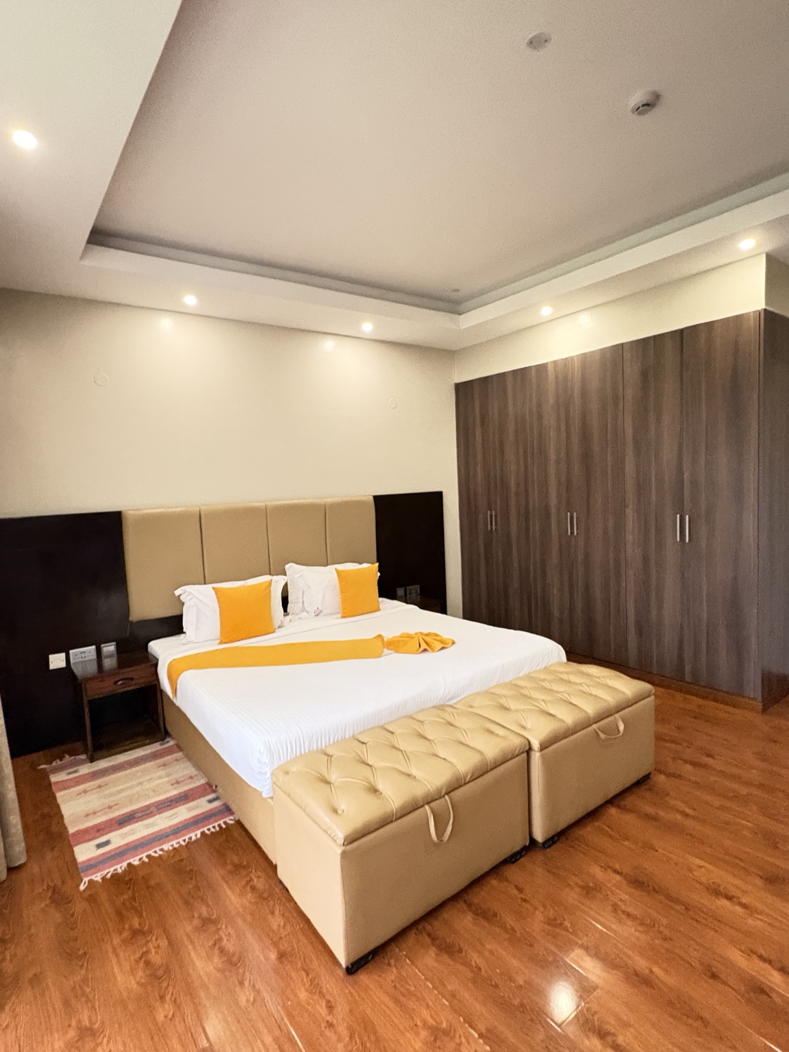 Villa 54 Deluxe Room with solid yellow bed runner
